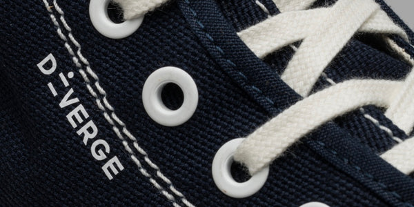 Low top sneakers personalised with the Diverge logo.