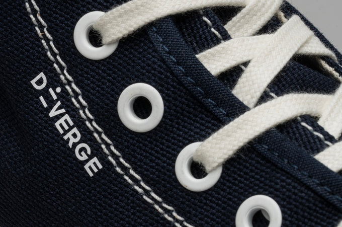 Low top sneakers personalised with the Diverge logo.