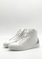 The MH0121 White & Artic Blue sneakers are a handcrafted pair of high-top shoes made in Portugal from premium Italian leathers, showcasing light blue heel accents and a lace-up closure on a plain white background.