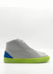 The MH0116 Grey & Electric Blue sneakers, handcrafted in Portugal, feature a bright green sole and a blue heel accent.