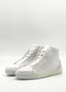 The MH0124 White & Plaster is a pair of white high-top sneakers, expertly handcrafted in Portugal from premium Italian leathers, set against a plain white backdrop. Ethically made to order, these sneakers blend style and sustainability with each step.