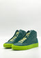 The MH0113 Emerald & Fluorescent Yellow high-top sneakers feature dark green uppers, light green laces, and bright green soles on a white background, handcrafted in Portugal using premium Italian leathers.