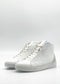 A side view of the MH0123 White & Plaster sneakers, featuring white high-tops with laces against a plain white background. These ethically made-to-order shoes are handcrafted in Portugal, using premium Italian leathers to ensure unparalleled quality and style.