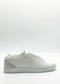 Introducing the ML0124 White Floater: a low-profile white leather sneaker meticulously crafted from premium Italian leathers. This elegant footwear features a suede heel detail, lace-up front, and durable rubber sole. Expertly handcrafted in Portugal, it is presented against a plain white background for an exquisite display.