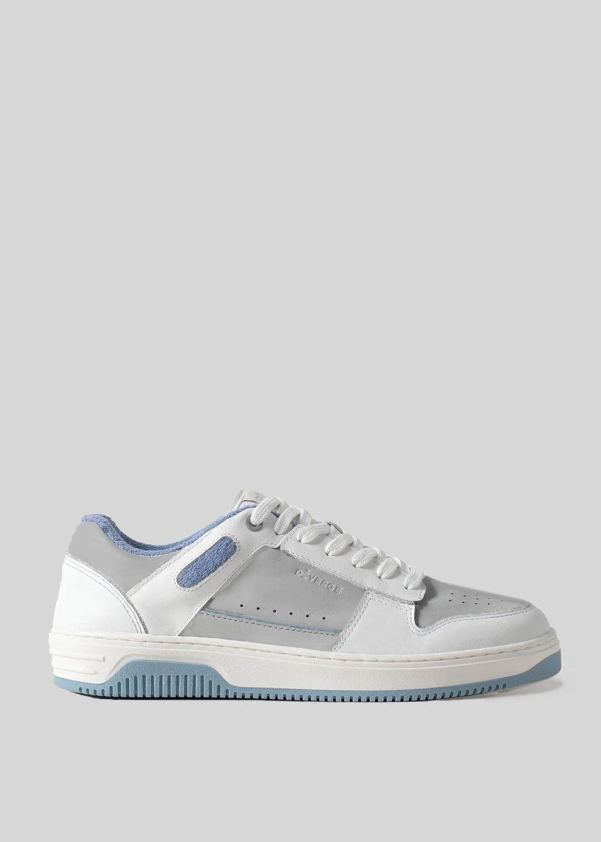 A white and light blue M0015 by Angelica sneaker, handcrafted in Portugal using premium Italian leathers, featuring perforations on the sides, a lace-up front, and a contrasting light blue sole. This retro-future sneaker is viewed from the side.