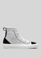 Side view of the TH0018 by Joice, a high-top sneaker for women in white and black with green accents, white laces, and a rubber sole against a plain grey background. Handcrafted in Portugal from premium canvas.