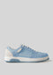 A light blue and white retro-future M0012 by Laila sneaker with a low-top design and white sole, handcrafted in Portugal from premium Italian leathers, is shown against a plain gray background.