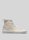 A beige high-top sneaker handcrafted in Portugal with white laces and trim, featuring a rubber toe cap and sole, displayed against a plain gray background is the TH0015 by Sofia.