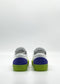 ML0116 White & Fluorescent Yellow sneakers with green soles and blue heel accents, handcrafted in Portugal from premium Italian leathers, displayed from the back against a plain white background.