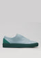 Slip-on sneaker in Artic blue with a Forest Green sole and heel cap, made from premium Italian leathers on a plain gray background, featuring a durable rubber cupsole.