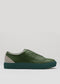 The V45 Pine W/ Forest Green is a handcrafted sneaker made in Portugal from premium Italian leathers, featuring a green textured leather upper, flat sole, light gray heel accent, and durable rubber cupsole. It is showcased on a plain background.