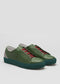 The V45 Pine W/ Forest Green sneakers, made from premium Italian leathers and featuring red laces and teal soles, are handcrafted in Portugal and showcased on a plain background.