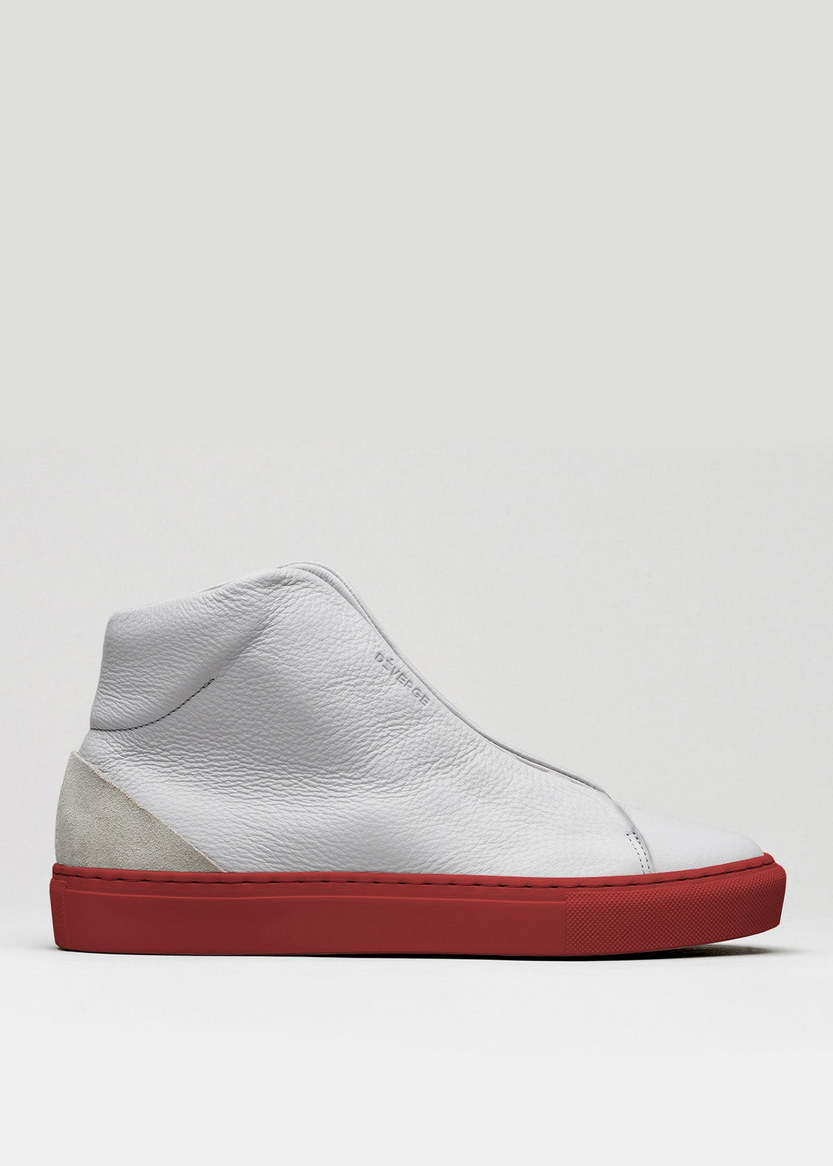 The V44 Grey W/ Red is a high-top sneaker, meticulously crafted with premium Italian leathers and adorned with a striking red sole and a convenient side zipper. Handcrafted in Portugal, this shoe seamlessly blends elegance with superior craftsmanship against a plain background.