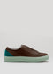 Side view of the V42 Brown W/ Pastel Green low top sneaker, crafted from premium Italian leathers. It showcases a brown upper with a teal heel accent and a light mint green sole, set against a plain gray background.