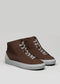 The V41 Brown W/ Plaster sneakers are a pair of brown high-top shoes, expertly handcrafted in Portugal from premium Italian leathers, featuring white soles and gray laces, displayed against a neutral background.