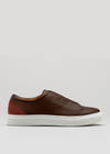 Crafted with ethical precision, the V41 Brown W/ Caramel slip-on sneaker showcases premium Italian leathers in a deep brown shade, highlighted by a sleek white sole against a neutral setting.