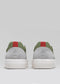 Back view of the V28 Pine & Grey low top sneakers, showcasing green, gray, and white panels with red pull tabs and white soles against a gray background. Handcrafted in Portugal from premium Italian leathers, these shoes blend exceptional quality with contemporary style.