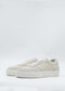 The N0025 Beige Floater sneakers are made from premium Italian leathers in white and beige with a flat sole, showcased against a plain background.