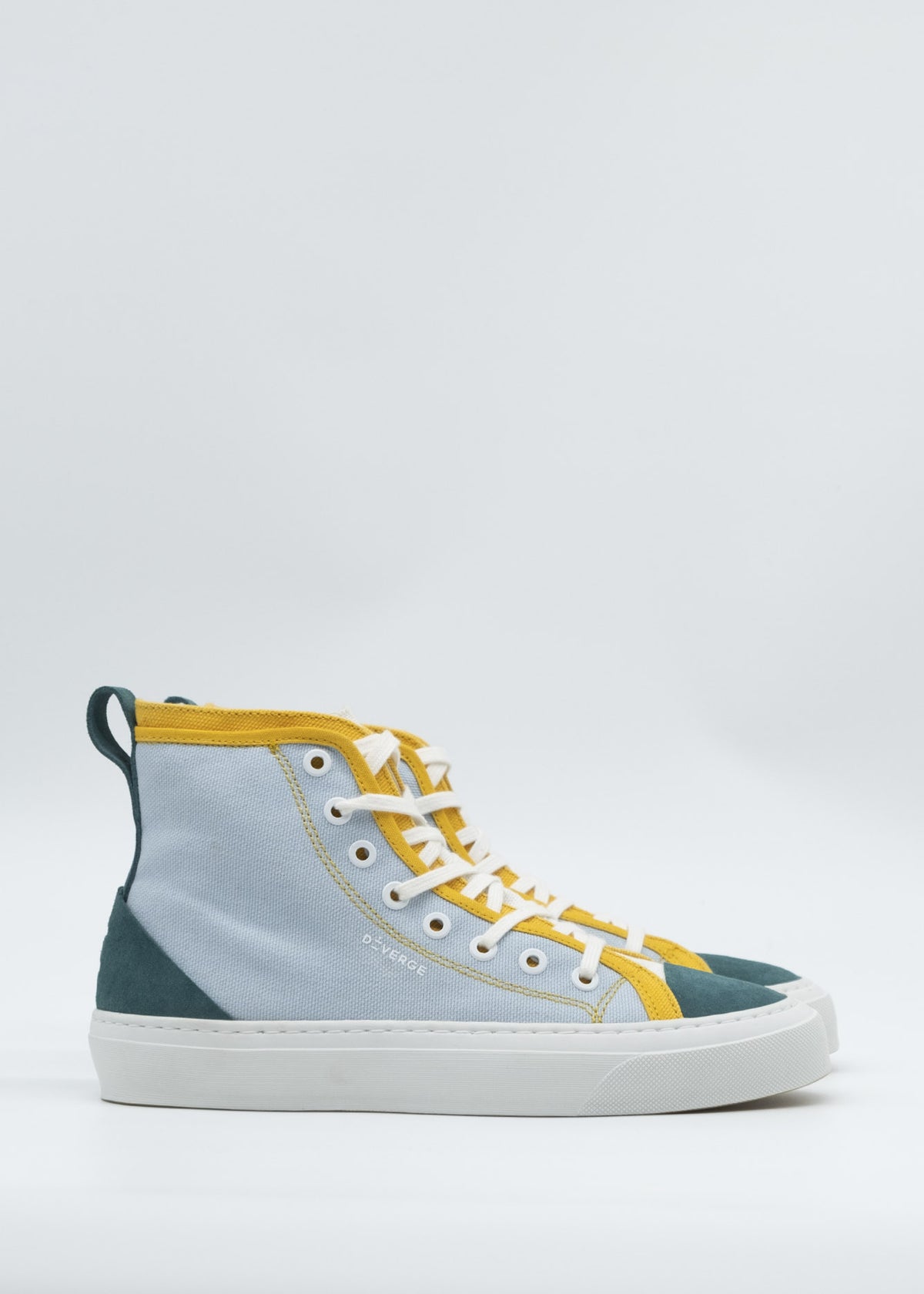 Introducing the TH0017 Blue & Green: a high-top sneaker featuring a premium canvas upper in blue and yellow, complemented by green accents on the heel and toe. It boasts a white sole, yellow laces, and is meticulously handcrafted in Portugal for exceptional craftsmanship.