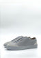 SO0038 Grey & White slip-on sneakers feature a smooth leather finish, are handcrafted in Portugal from premium Italian leathers, and have subtle branding on the side against a plain background.