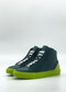 MH0139 Emerald Green & Lime high-top sneakers feature dark teal uppers, white laces, and bright green soles, highlighting their handcrafted elegance against a plain background. These sneakers are ethically made from premium Italian leathers, offering a perfect blend of style and sustainability.