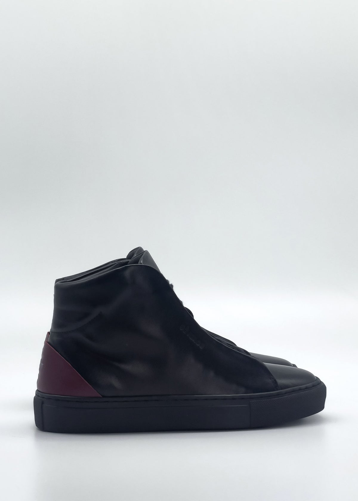 The MH0140 Black & Scarlet is a black high-top sneaker with a maroon accent on the heel, crafted from premium Italian leathers and displayed against a white background.