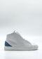 The MH0143 White & Blue sneaker is handcrafted in Portugal using premium Italian leathers, featuring a distinctive blue heel accent on a plain white background. Ethically made to order, it combines style with a commitment to ethical production.