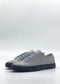 The ML0114 Grey & Black sneakers boast a sleek design with gray hues, striking blue accents, and durable black soles. Made from premium Italian leathers, they are ethically crafted to order, combining style with conscience in every step.