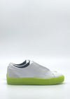 The ML0111 White & Lime sneakers, depicted in a side view against a plain background, feature bright lime soles and are handcrafted in Portugal using premium Italian leathers.