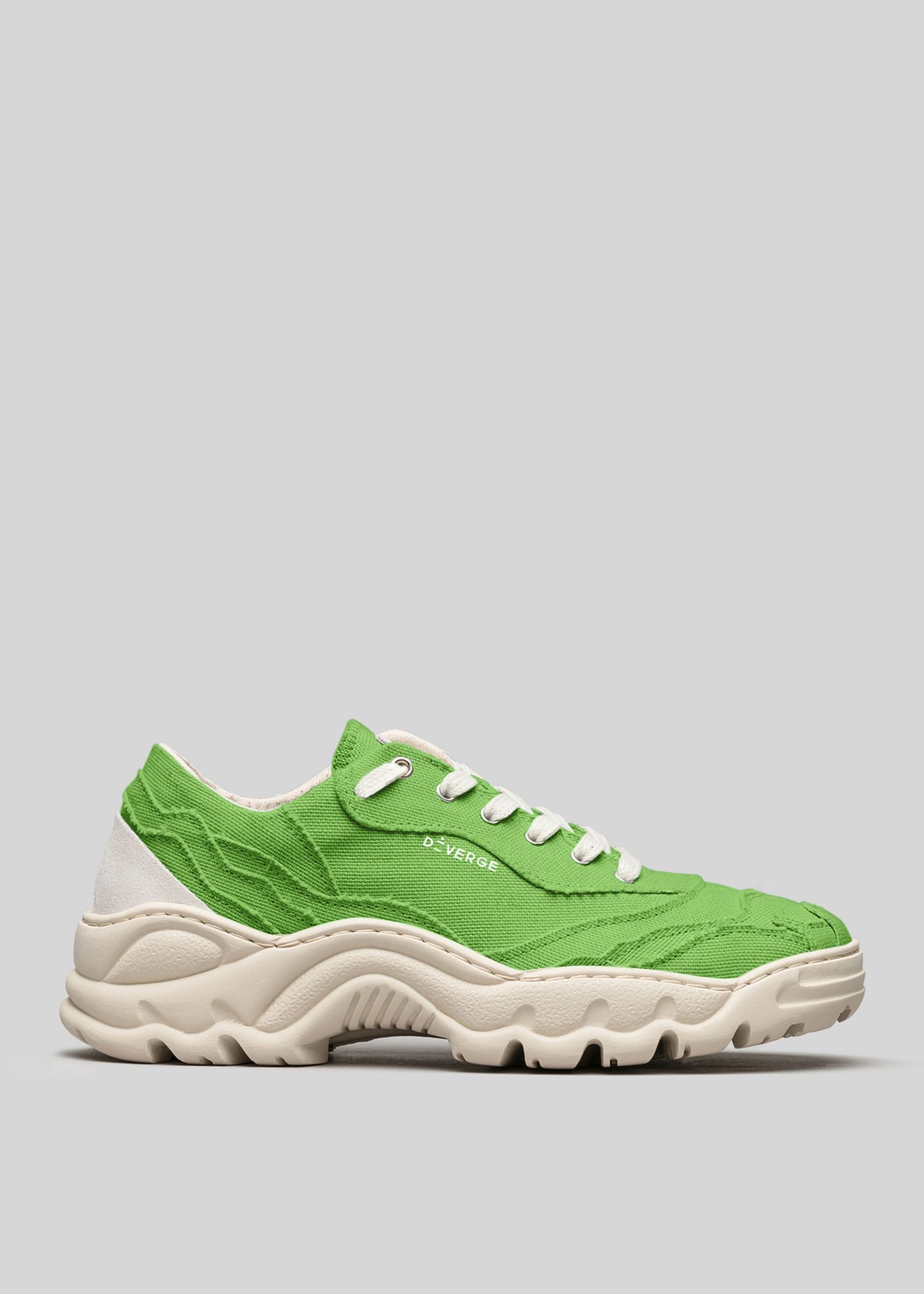 The V11 Brat is a green sneaker featuring white laces and a white sole, made from Italian leathers with "D-VERGE" printed on the side, photographed against a gray background.