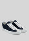 The V4 Blue & Grey are stylish low-top sneakers with a navy and white color scheme, featuring white laces and a rubber sole. They are handcrafted in Portugal from premium canvas and displayed on a plain gray background.