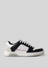 Introducing the M0018 by Mariana, a retro-future sneaker handcrafted in Portugal. Made from premium Italian leathers, this black and white low-top features a sleek white sole, black laces, and a subtle red accent line for an elevated style.