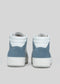 A rear view of the V7 White W/ Arctic Blue sneakers, showcasing their retro-future high-top design in white and blue, handcrafted in Portugal, set against a plain gray background.