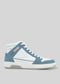 Introducing the V7 White W/ Arctic Blue: a high-top sneaker featuring white and light blue panels, complemented by white laces and a textured white sole. Handcrafted in Portugal using premium Italian leathers, the sneaker is displayed on a gray background.