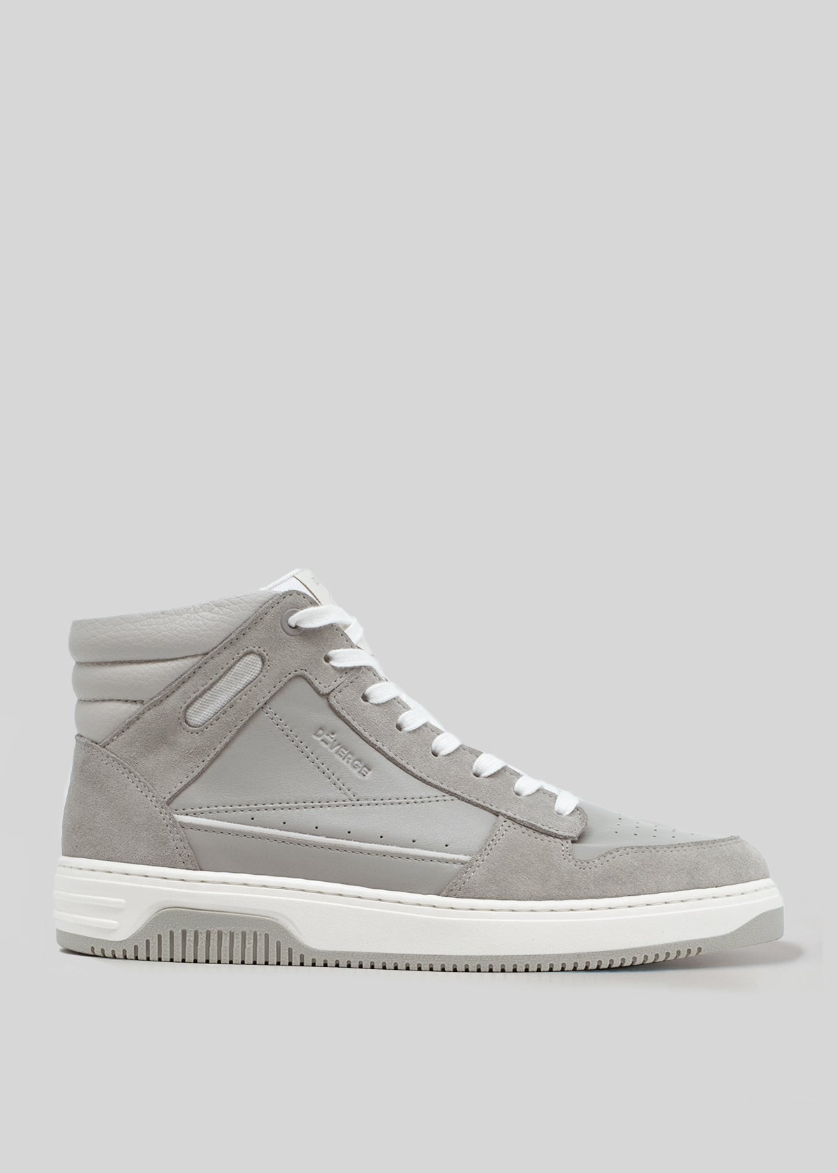 The V4 Grey W/ Plaster, a high-top sneaker crafted from premium Italian leathers, features white laces and a white sole. Elegantly displayed on a plain grey background, this piece is handcrafted in Portugal and beautifully combines artistry with superior craftsmanship.