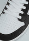 Close-up of the V3 Black W/ White high top sneaker featuring a white perforated toe box, black trim, and white laces, handcrafted in Portugal using premium Italian leathers.