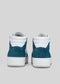 A pair of V1 Petrol Blue w/ White high-top sneakers, handcrafted in Portugal from premium Italian leathers, viewed from the back against a plain gray background.