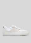 The V31 White & Plaster is a white and light gray sneaker with a flat sole, handcrafted in Portugal from premium Italian leathers, displayed against a plain gray background.