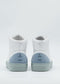 MH0134 White & Blue high-top sneakers, featuring gray-blue suede accents on the heels and handcrafted in Portugal, viewed from the back against a plain white background.