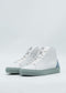 A pair of MH0134 White & Blue made-to-order high-top sneakers with gray soles on a light background, crafted from premium Italian leathers and viewed from a slight angle.