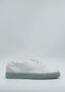 A pair of ML0104 Pastel Green & White sneakers, featuring a gray sole and crafted from premium Italian leathers, showcased against a plain background.