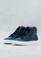 A pair of ocean blue high-top sneakers with white soles, handcrafted in Portugal, positioned on a light gray background.