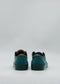 A pair of ML0102 Emerald Green Floater sneakers, crafted from premium Italian leathers, elegantly viewed from the back against a plain light gray background.