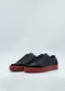 SO0036 Black & Red slip-on sneakers feature a matte finish and red rubber soles, handcrafted in Portugal using premium Italian leathers, presented against a plain background.