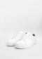 A pair of ML0038 White Leather shoes, featuring a simple white design with flat soles and white laces, set against a plain white background.