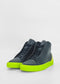 ML0098 Black high-top sneakers featuring bright neon green soles, crafted from premium Italian leathers, are set against a white background.