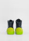 ML0098 Black high-top sneakers, handcrafted from premium Italian leathers, featuring bright green soles and heel accents, viewed from the back on a white background.