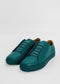 A pair of ML0071 Emerald Green Floater, ethically made-to-order with premium Italian leathers and matching teal laces, boasts a low-top design. They are placed on a plain white background. Handcrafted in Portugal for impeccable quality.