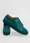 Pair of ML0071 Emerald Green Floater sneakers with textured, premium Italian leathers and matching laces, one shoe placed horizontally on top of the other against a plain white background. These sneakers are handcrafted in Portugal and ethically made-to-order for a perfect blend of style and conscience.