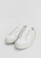 A pair of ML0085 White W/ Yellow sneakers, handcrafted in Portugal from premium Italian leathers, with white laces and a yellow detail on the heel, placed against a plain white background.